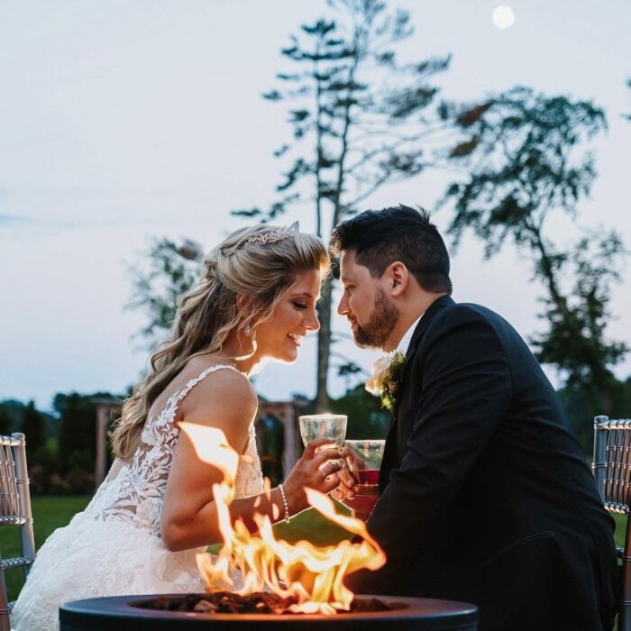 bride and groom sitting close and having drinks